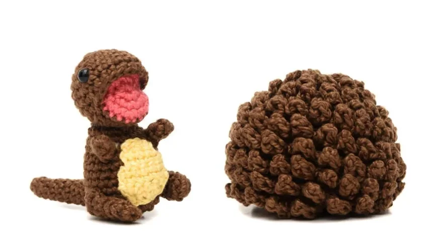 Ovo com filhote de dinossauro marrom em amigurumi