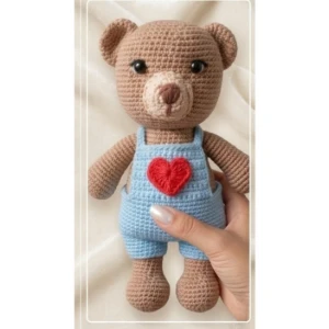 Ursinho de Amigurumi com Jardineira Azul e Coração - Artesanato e Personalizados
